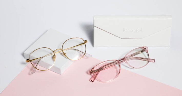 gold framed eyeglasses on white paper