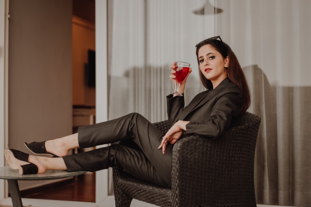 woman in black long sleeve shirt sitting on black and gray armchair