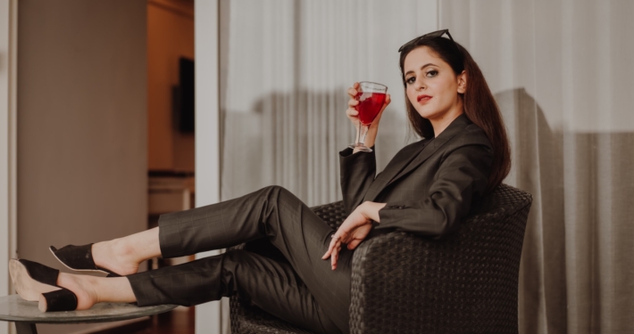 woman in black long sleeve shirt sitting on black and gray armchair