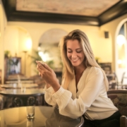 Cheerful female having drink in elegant bar