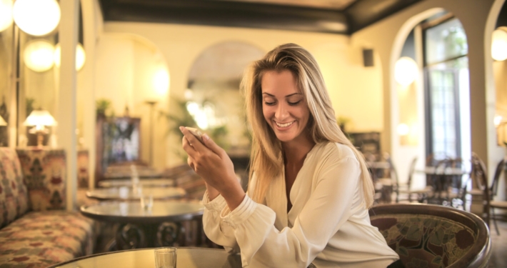 Cheerful female having drink in elegant bar