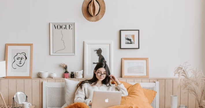 Woman Using Laptop In Bed