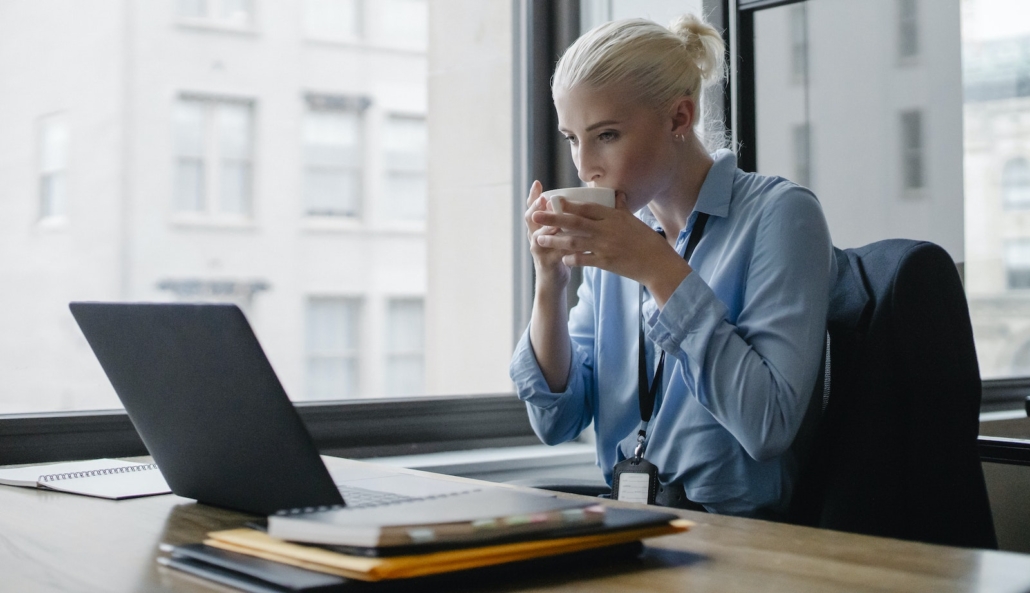 Female manager drinking coffee at workplace