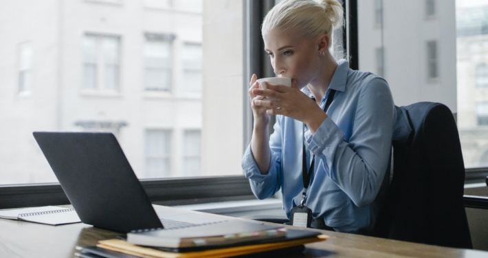 Female manager drinking coffee at workplace