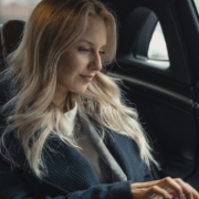 Beautiful Woman in Blue Coat Sitting in the Car