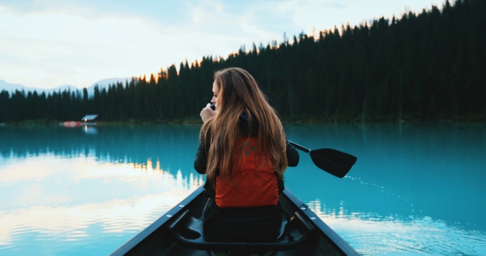 blonde haired woman riding on boat