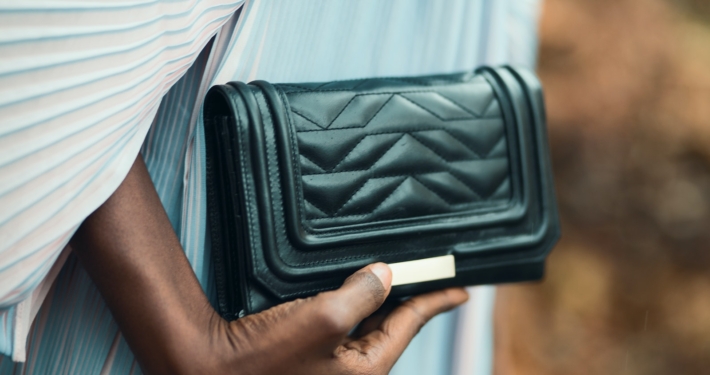 Person Holding Quilted Black Leather Clutch Bag