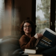 woman in brown coat using black laptop computer