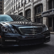 a black car parked on the side of a street