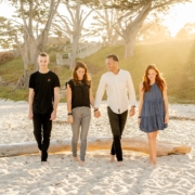 3 women standing on white sand during daytime