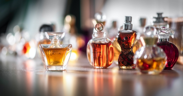 selective focus photography of clear glass perfume bottle