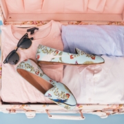 clothing items and pair of shoes in luggage