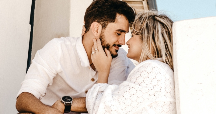 smiling man and woman about to kiss