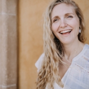 smiling woman in white lace shirt