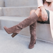 woman wearing pair of brown leather boots