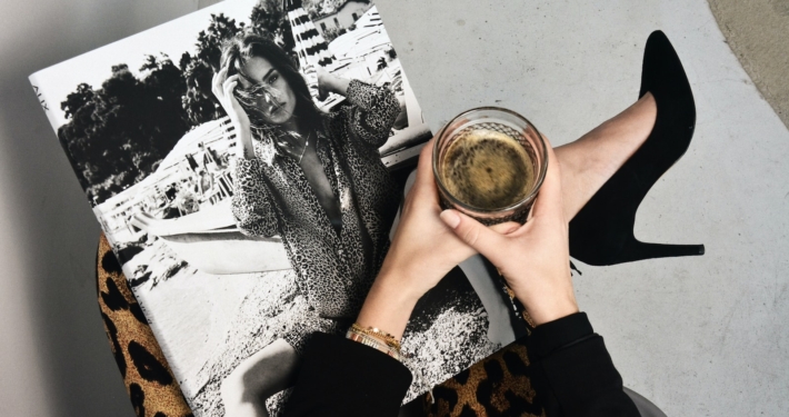 woman holding clear glass candle holder and grayscale portrait of a woman