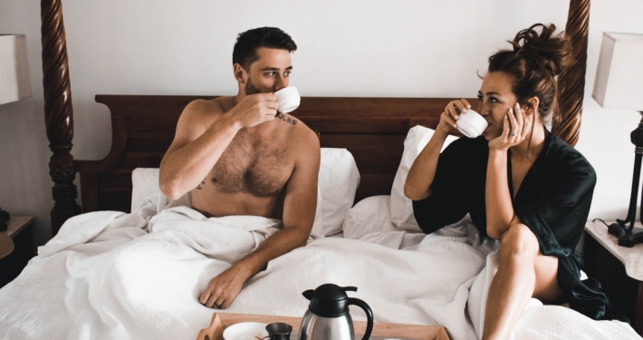 man drinking some coffee beside woman