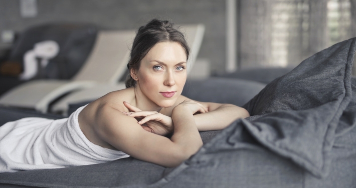 Woman Covered in Towel Lying on Bed