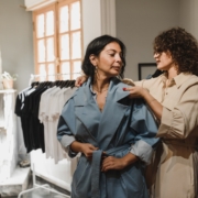 Woman in Blue Dress Standing Beside Woman in Brown Coat