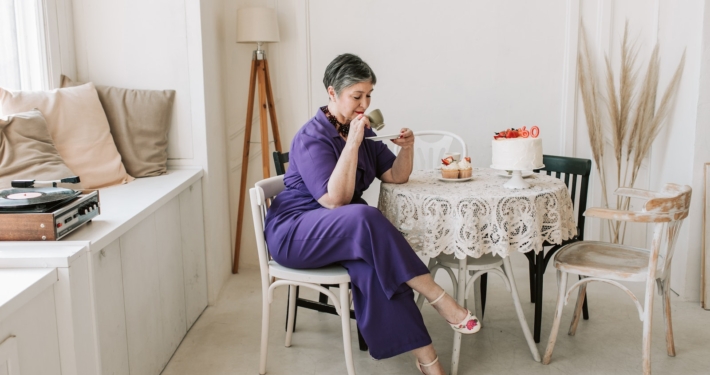 Woman in Purple Jumpsuit Holding Cup