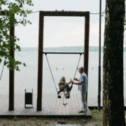 Elderly Woman riding a Swing with her Husband holding the Rope