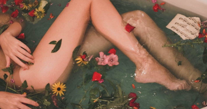 bathtub with water and flowers