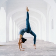 woman in blue leggings and black tank top doing yoga