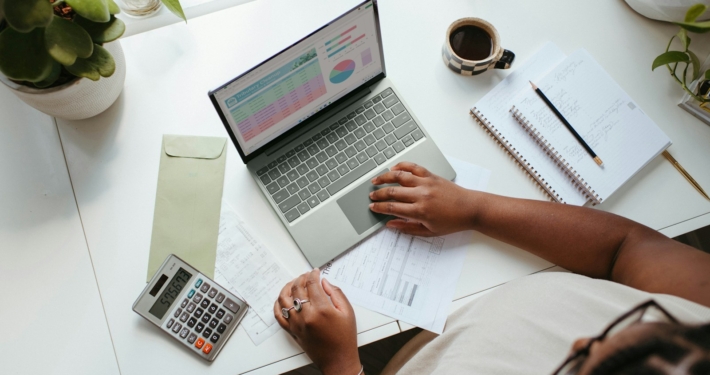a person sitting at a table with a laptop