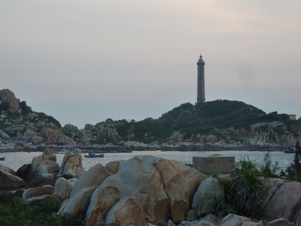 Dusk settles over the Ke Ga lighthouse and the rocky cape opposite.