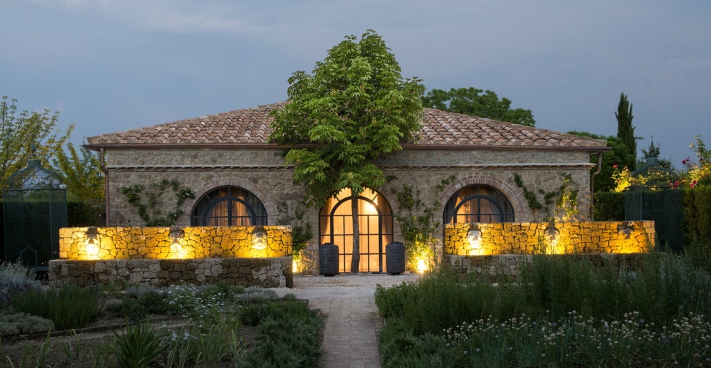 The stone-built Seed to Skin spa lit at dusk.
