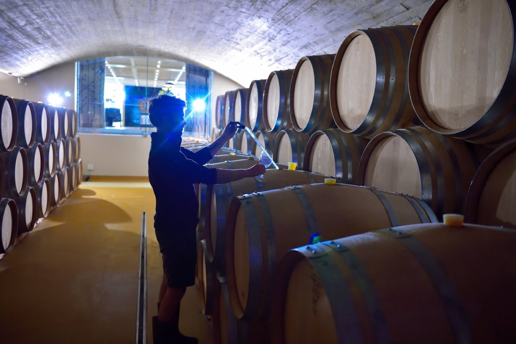Barrel cellar at Delaire Graff Estate with a winemaker at work.