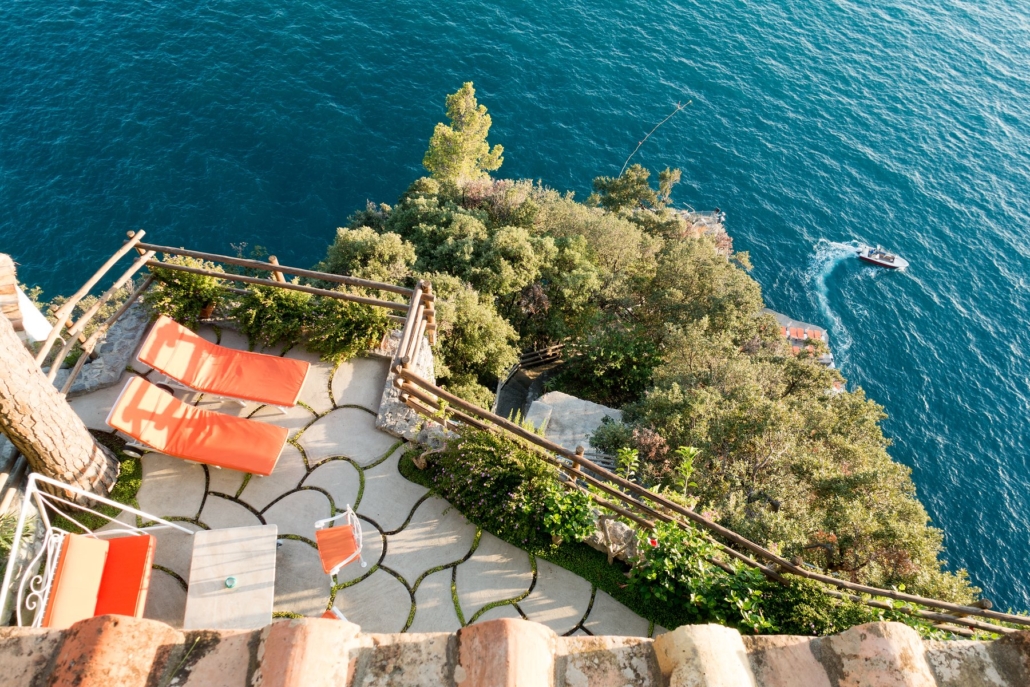 A sea-facing terrace at Il San Pietro, hung with bougainvillea.