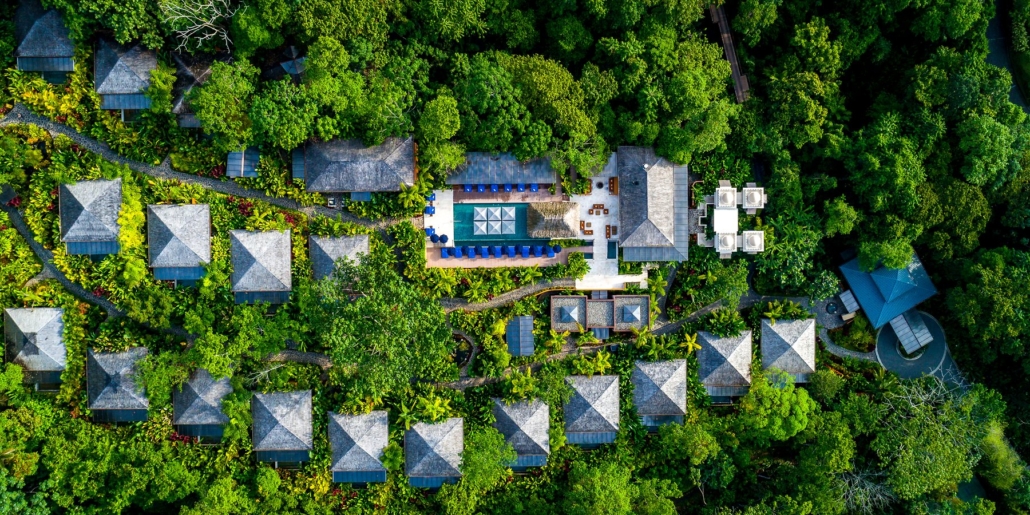 Nayara Springs' villas scattered through the rainforest, seen from the air.
