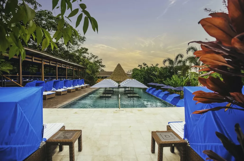 The pool beside the Cielito Lindo pool bar at Nayara Springs, framed by tropical planting.