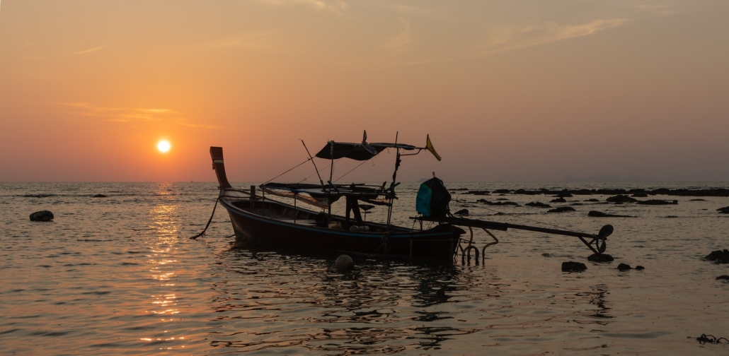 A longtail boat at sunset off Koh Lanta’s west coast.