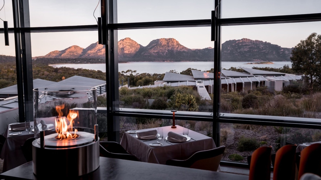 Firelit tables inside the lodge as the Hazards turn pink at dusk.